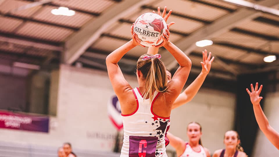 a player jumping up and holding the ball